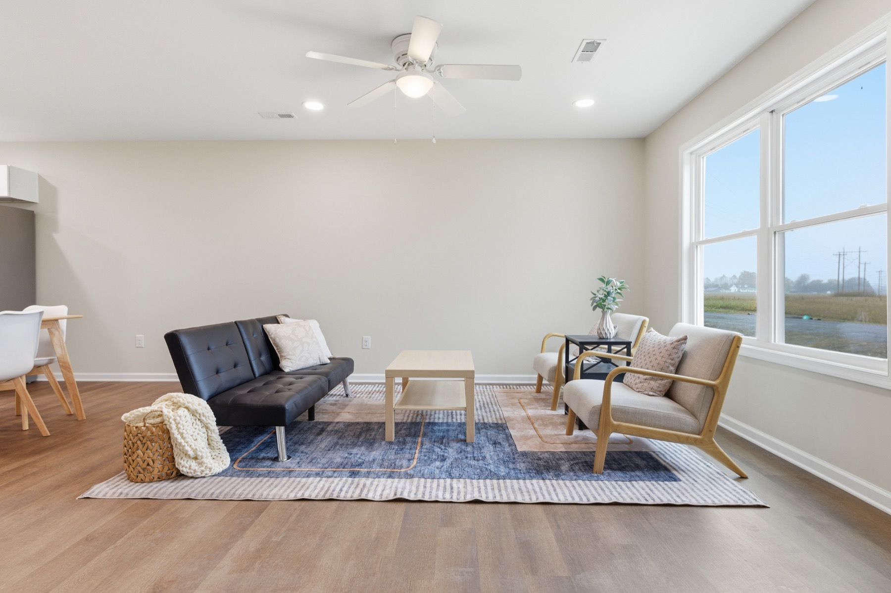 Living room with luxury vinyl plank flooring and large windows