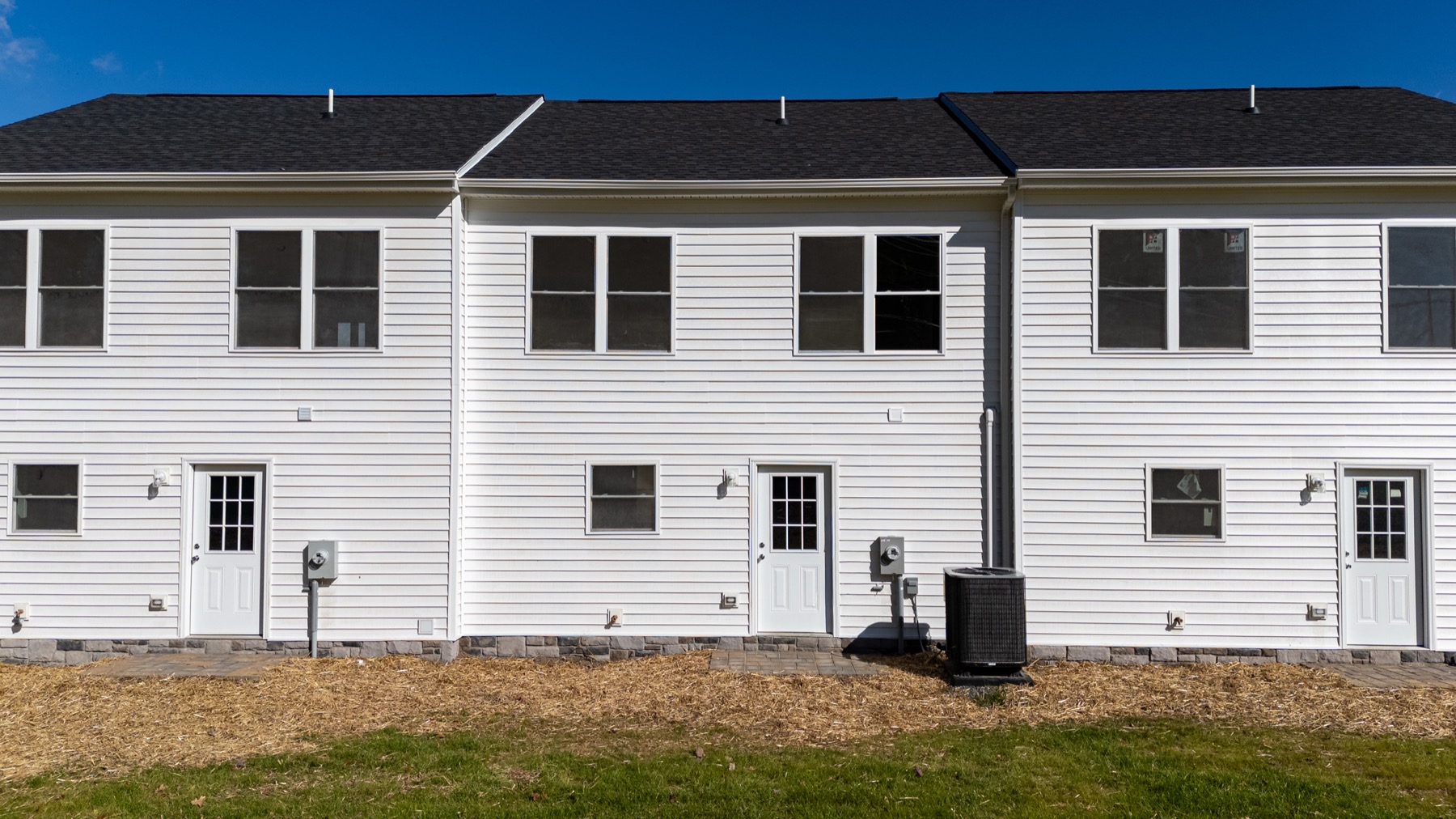 Back of the townhomes facing open farmland